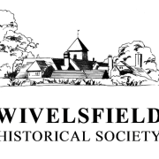 Line drawing of village buildings and trees above the text "Wivelsfield Historical Society ©".